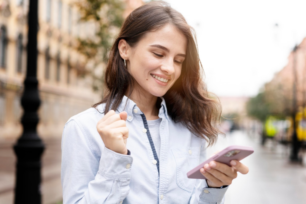 Smiling woman using her phone