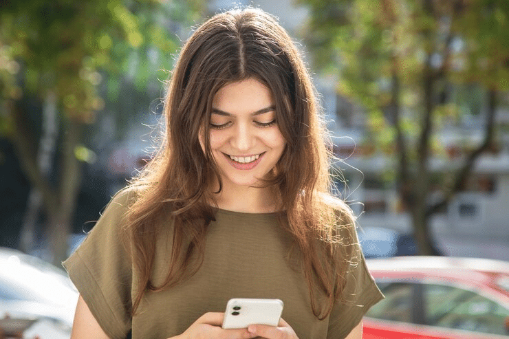 girl texting on a phone and smiling
