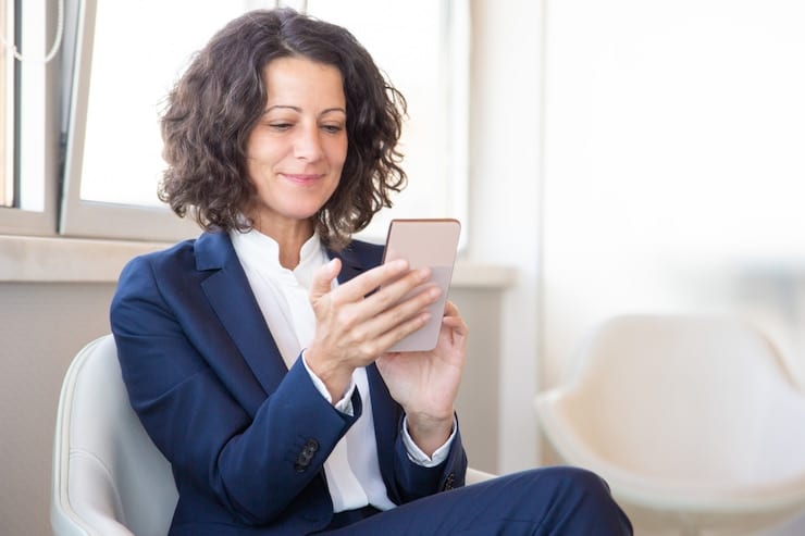 businesswoman texting on a mobile phone