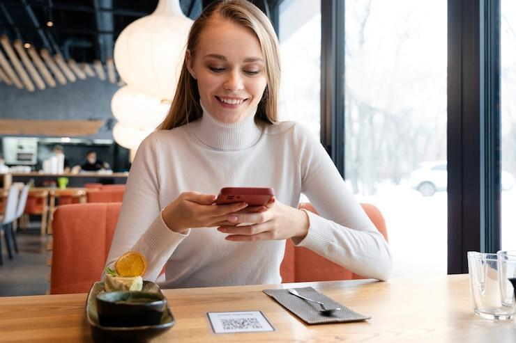 Woman in bar using her phone