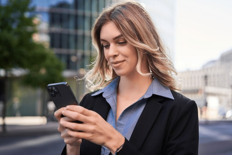 woman looking at a phone and smiling