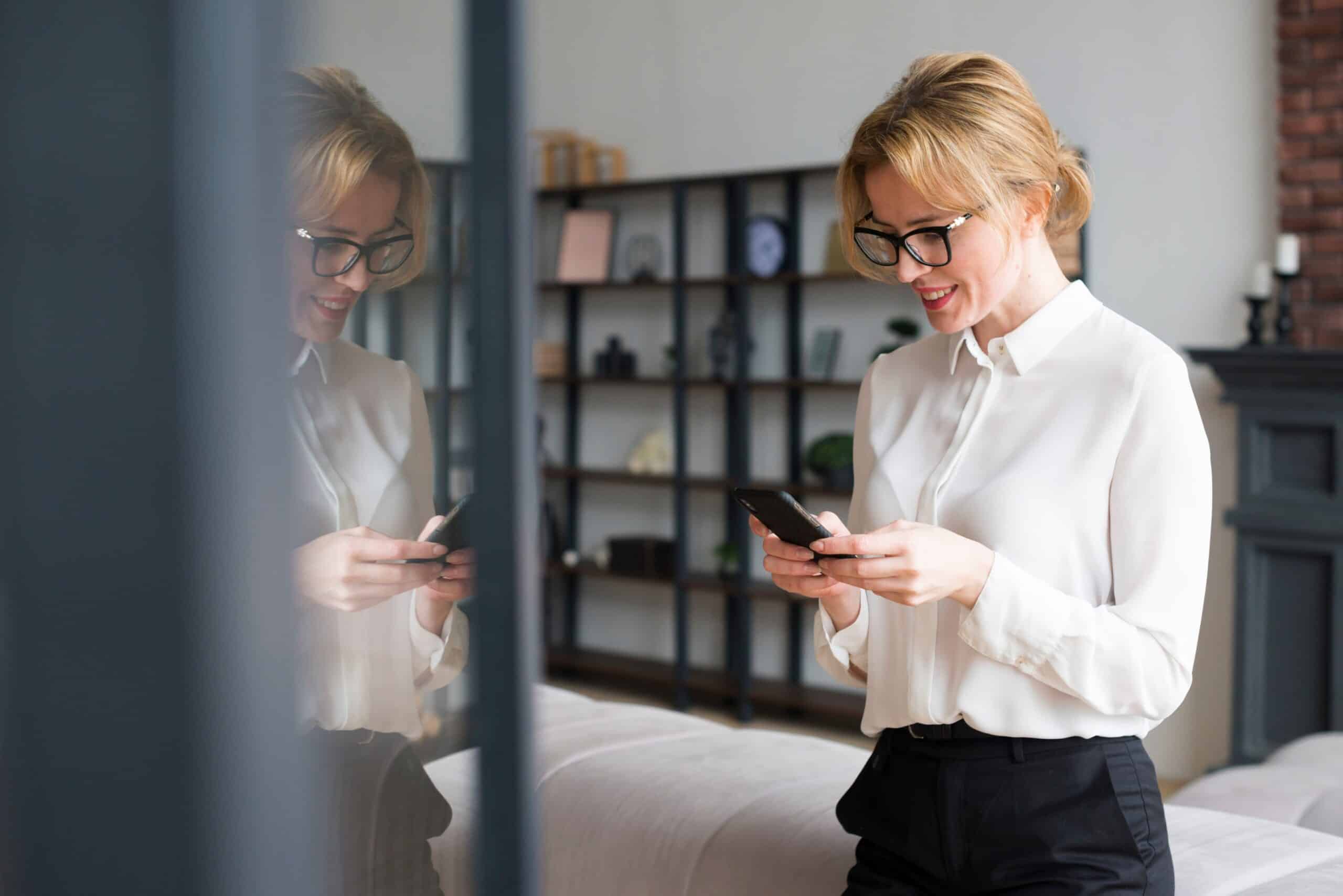 Smiling woman using her phone