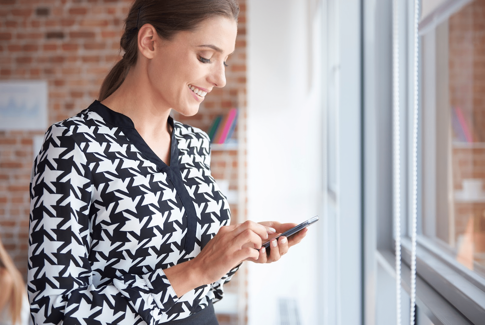 Woman with a smile holding a phone