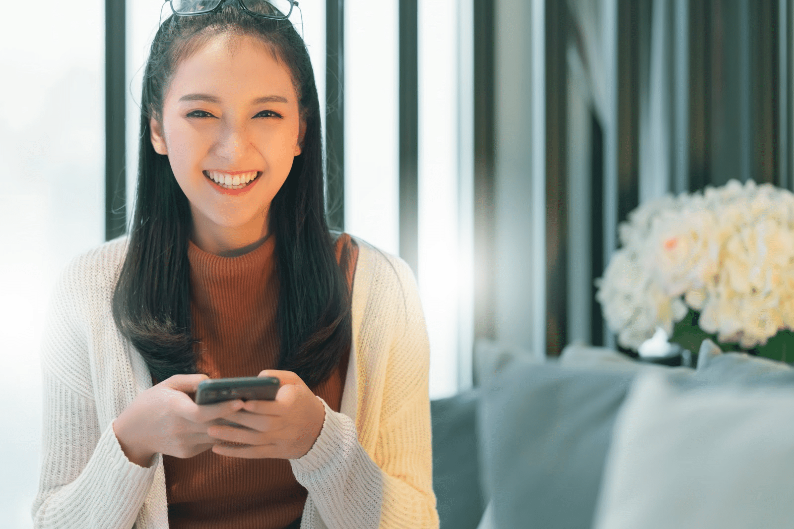 Woman with a smile holding a phone