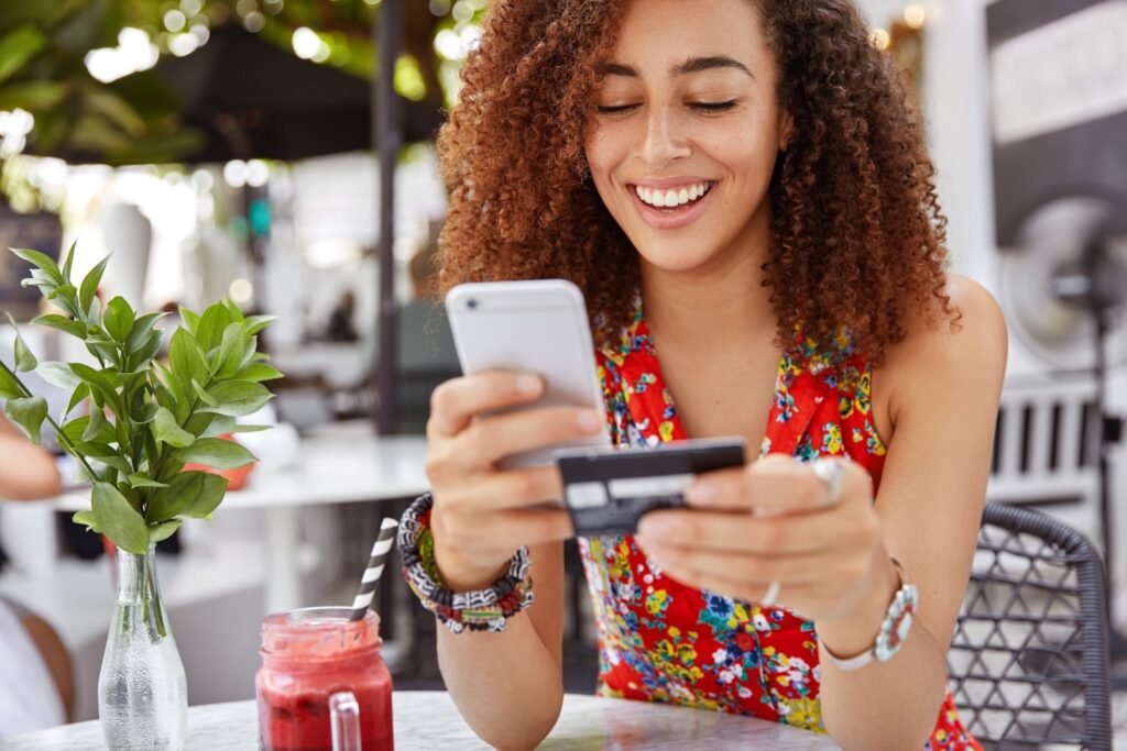 a woman smiling while using a phone