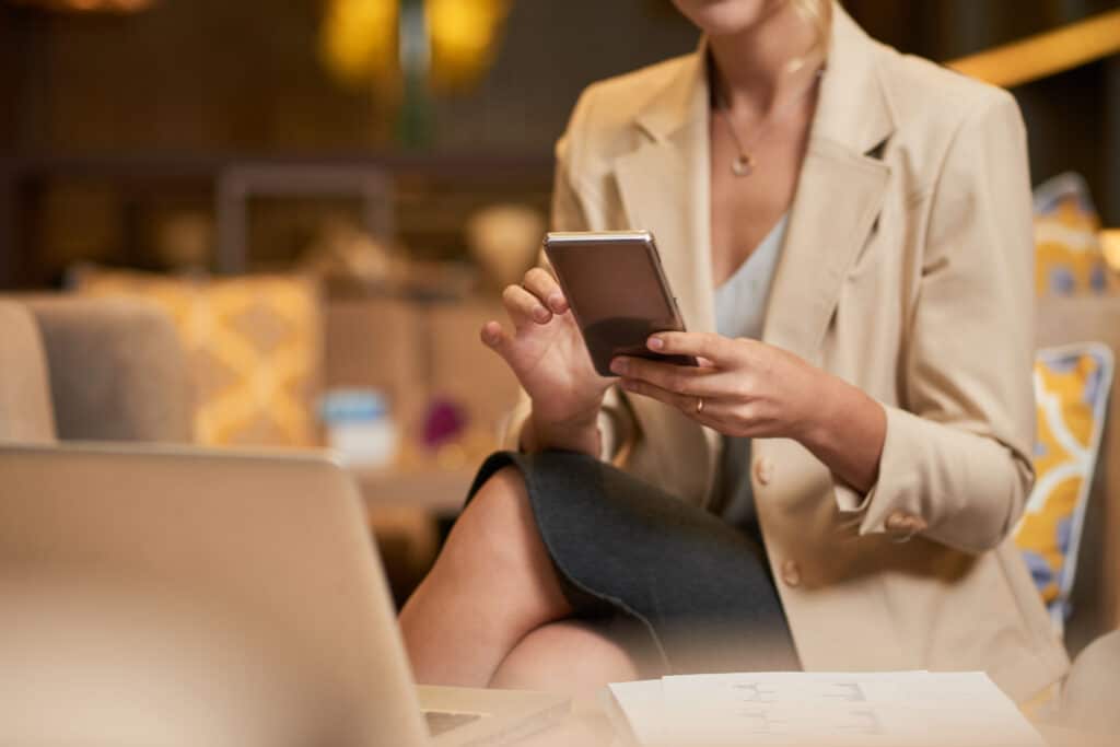 a business woman using a mobile phone in a hotel