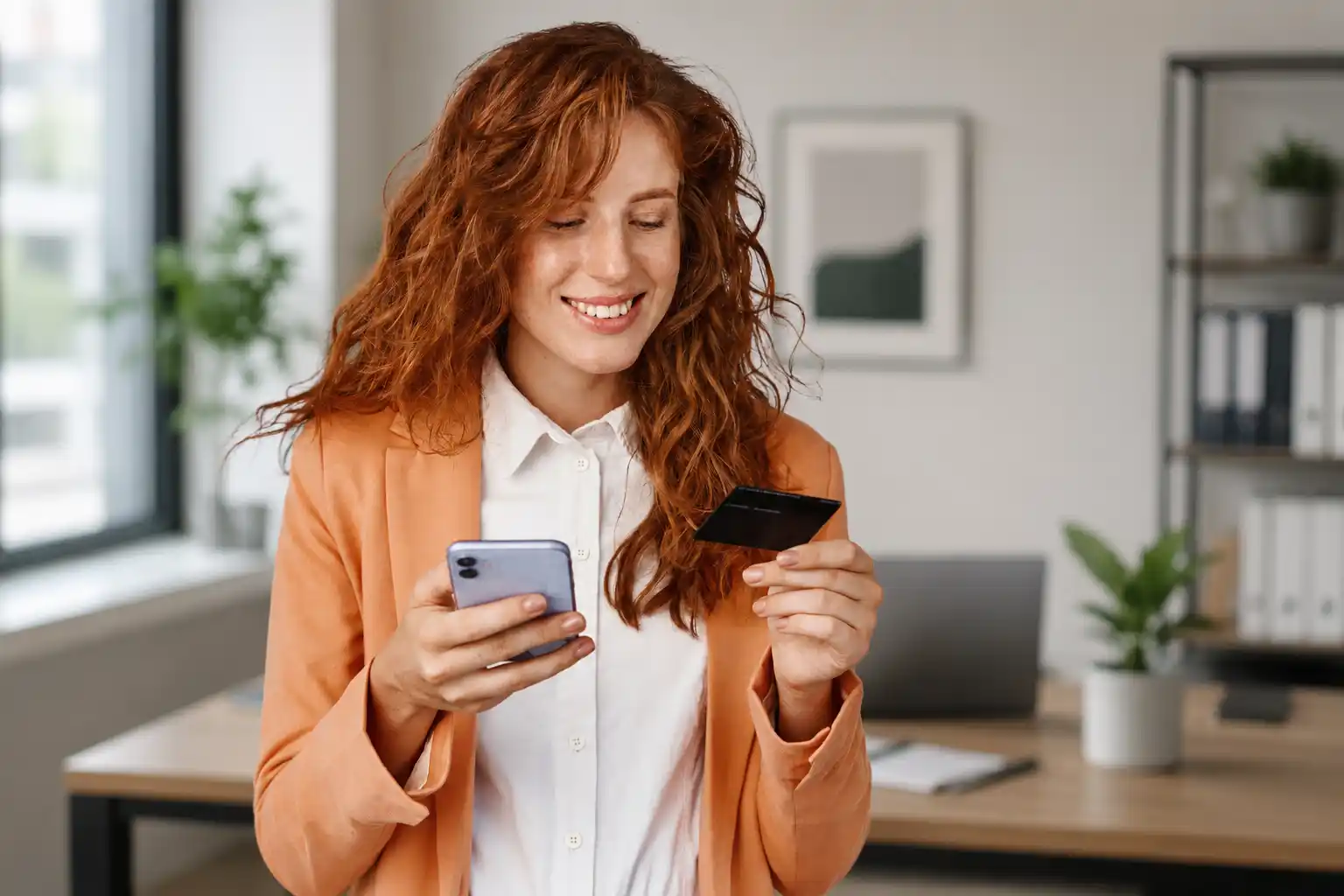 Woman checking a text message alert and payment card on her phone